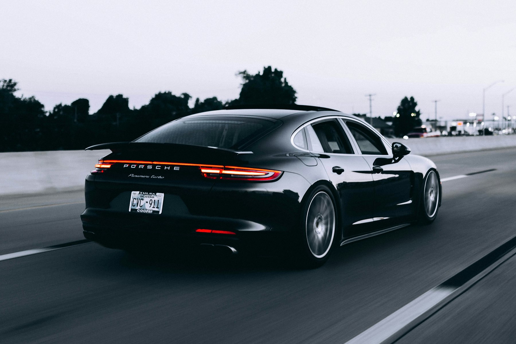 A dark sports car photographed in motion.