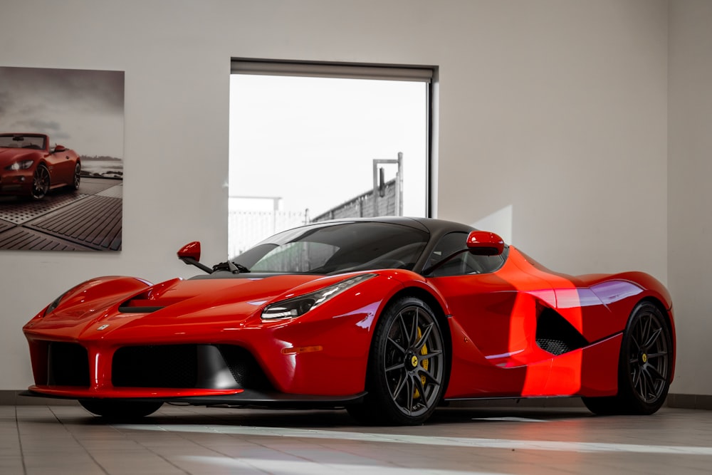 Red supercar in a white showroom